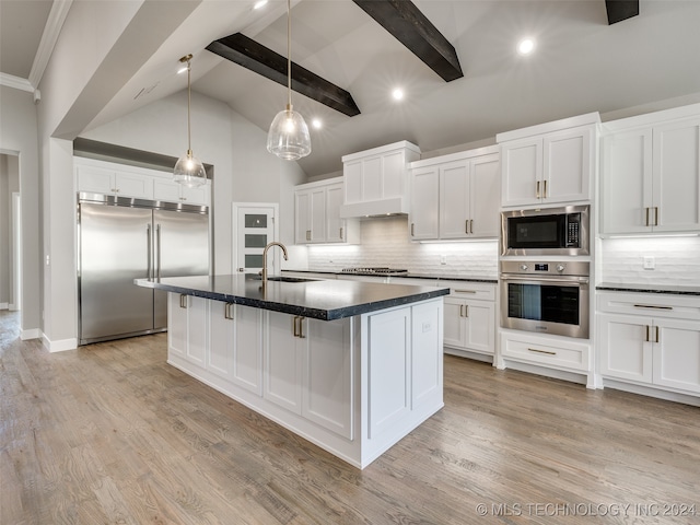 kitchen with white cabinets, sink, built in appliances, decorative backsplash, and beam ceiling