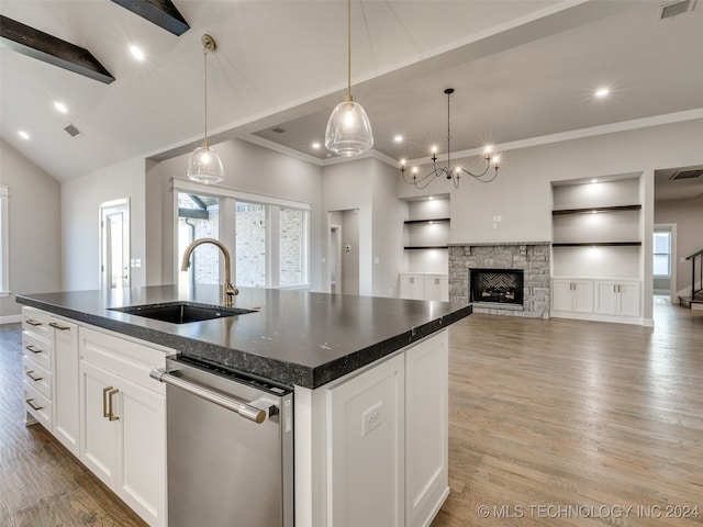 kitchen with white cabinetry, sink, light hardwood / wood-style flooring, stainless steel dishwasher, and a kitchen island with sink