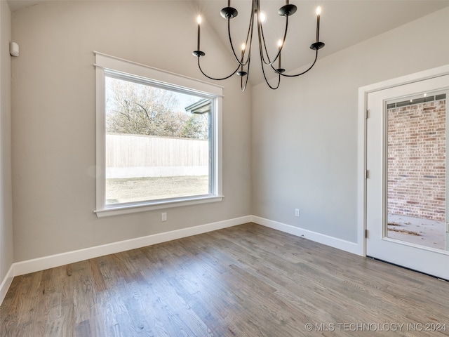 unfurnished dining area with light hardwood / wood-style floors and a notable chandelier