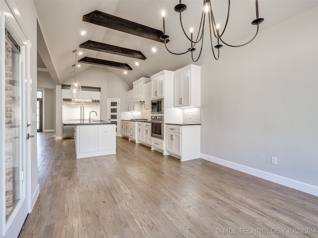 kitchen featuring built in appliances, light hardwood / wood-style floors, white cabinets, and sink