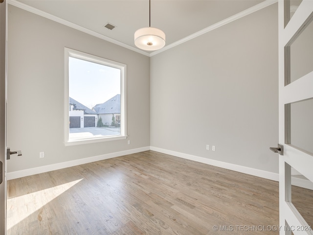 unfurnished room featuring crown molding and hardwood / wood-style flooring