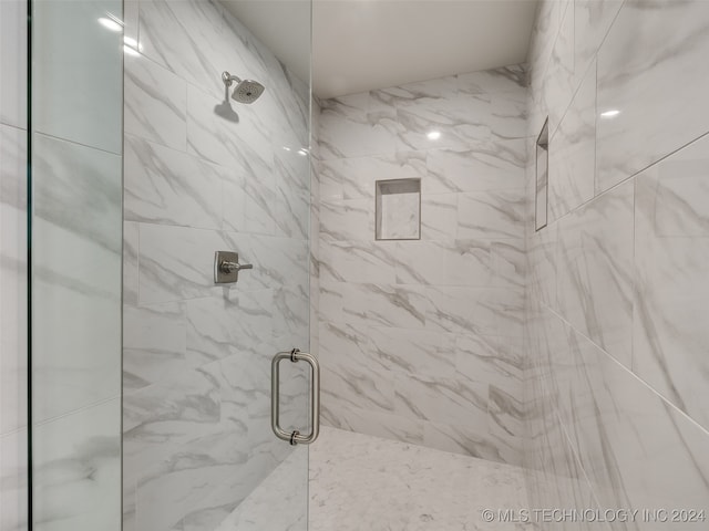 bathroom with a shower with door