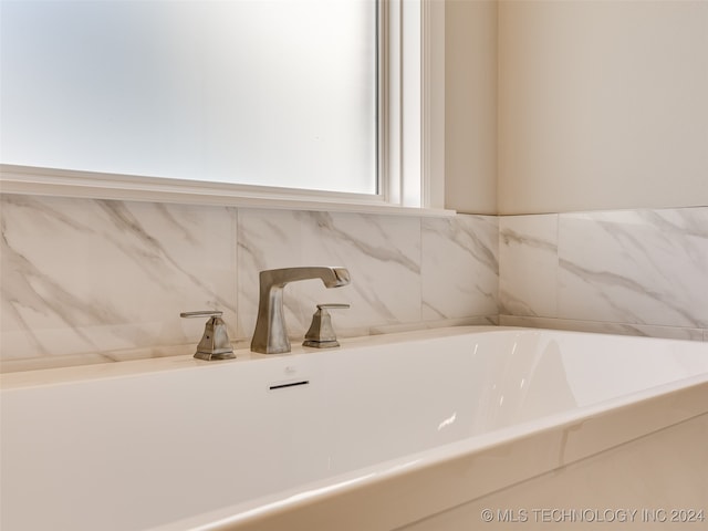 bathroom featuring a bath and sink