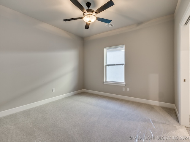 unfurnished room featuring ceiling fan and light colored carpet