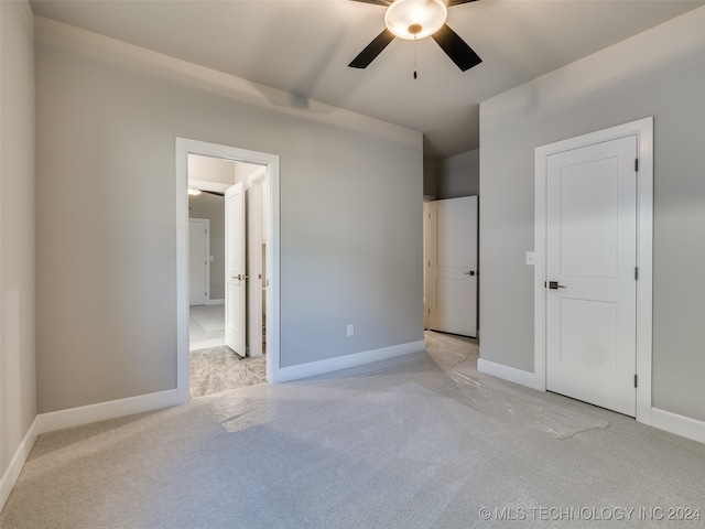 unfurnished bedroom with ceiling fan and light colored carpet