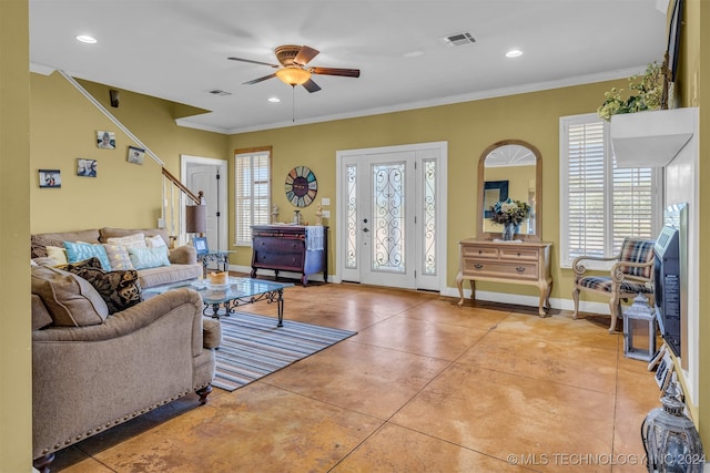 tiled living room with plenty of natural light, ceiling fan, and ornamental molding