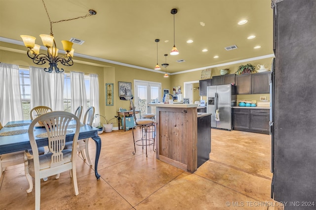 kitchen featuring a chandelier, hanging light fixtures, stainless steel refrigerator with ice dispenser, ornamental molding, and a kitchen bar