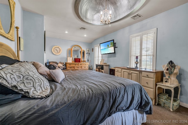 bedroom with light colored carpet and an inviting chandelier