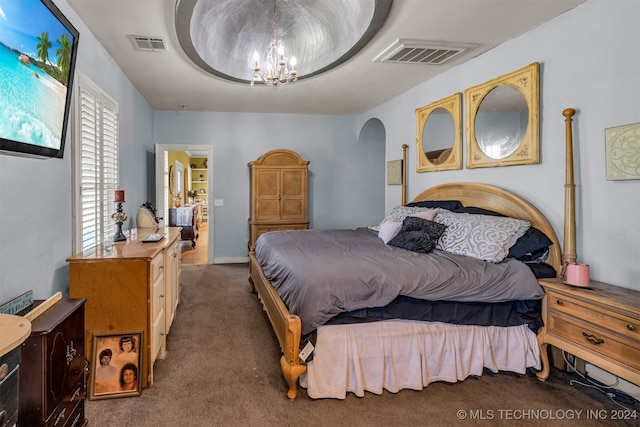 carpeted bedroom featuring an inviting chandelier