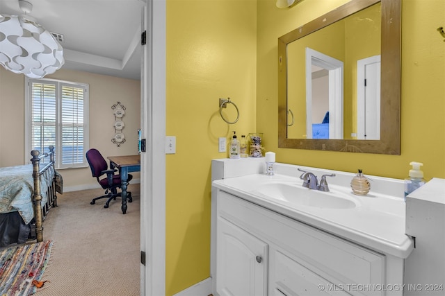 bathroom featuring vanity and a raised ceiling