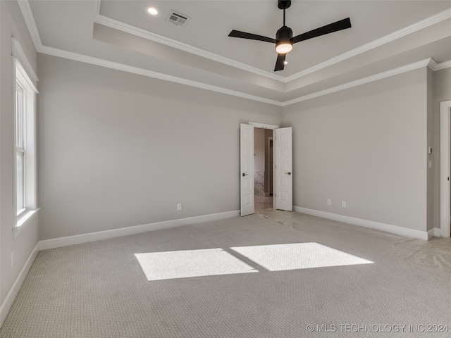 empty room with light colored carpet, ceiling fan, and crown molding