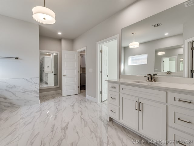 bathroom with vanity, tile walls, and walk in shower