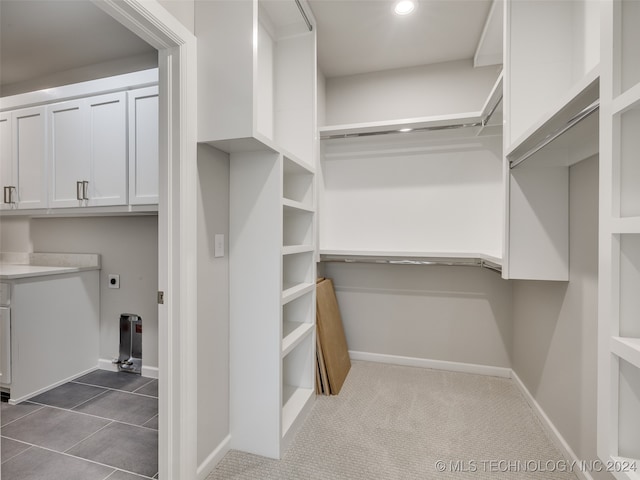 walk in closet featuring dark tile patterned floors