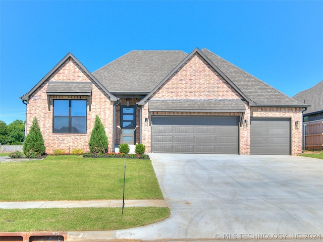 view of front of home with a garage and a front yard