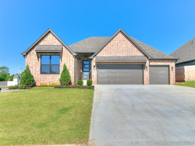 view of front of property featuring a garage and a front yard