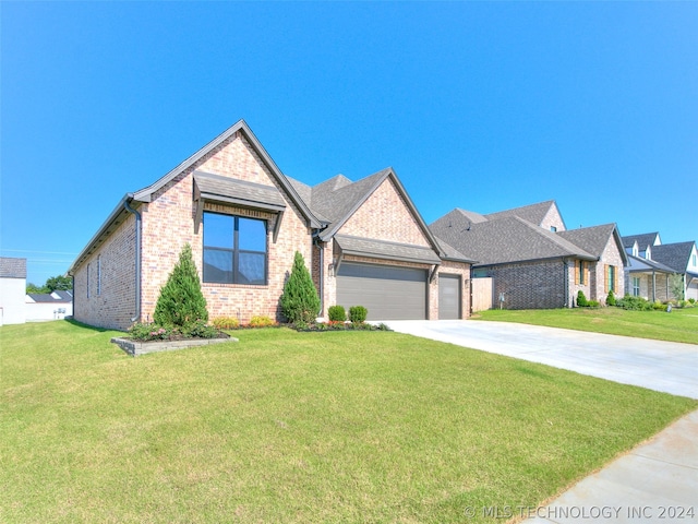 view of front of property with a garage and a front lawn