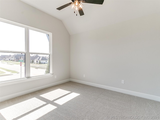 empty room with carpet flooring, ceiling fan, and vaulted ceiling