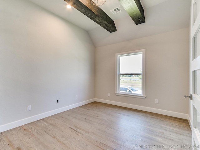 unfurnished room with light hardwood / wood-style floors and vaulted ceiling with beams