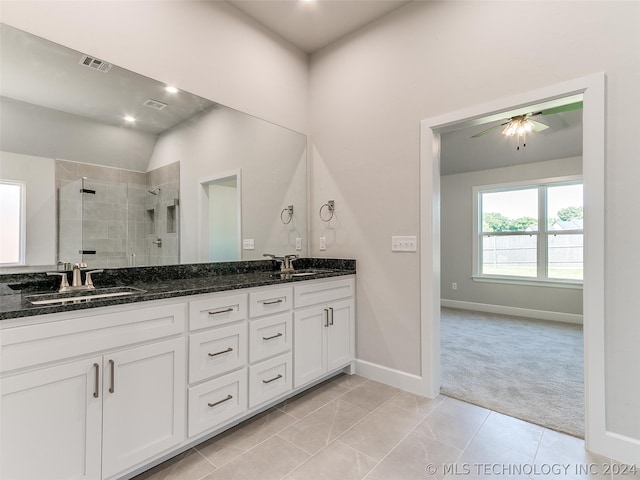 bathroom with ceiling fan, walk in shower, tile patterned floors, and dual bowl vanity