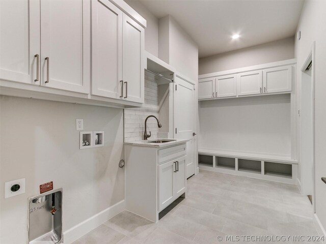 laundry area with sink, hookup for a washing machine, cabinets, and hookup for an electric dryer