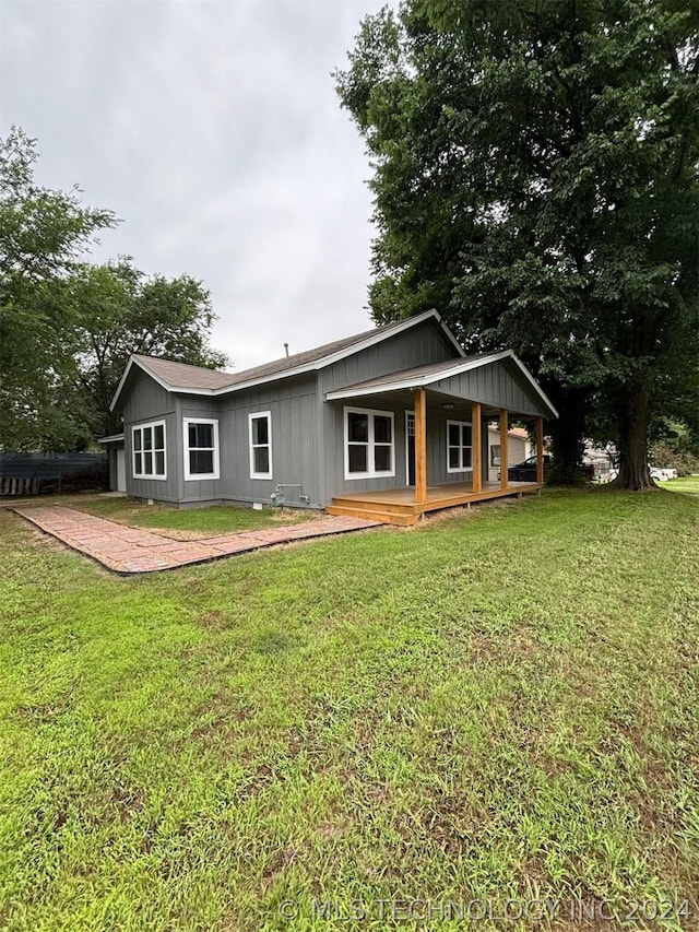 back of house with a lawn