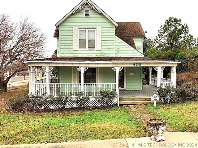 country-style home featuring a front yard and a porch