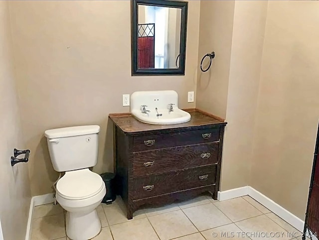 bathroom with tile patterned floors, vanity, and toilet