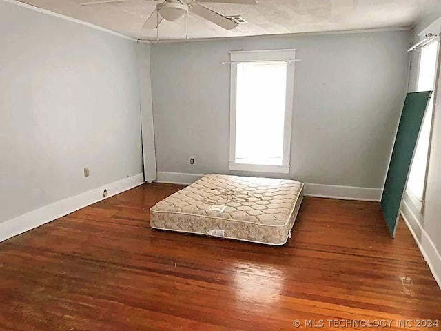 bedroom with ceiling fan and dark hardwood / wood-style floors