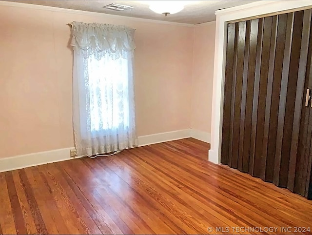 empty room featuring hardwood / wood-style floors and a healthy amount of sunlight