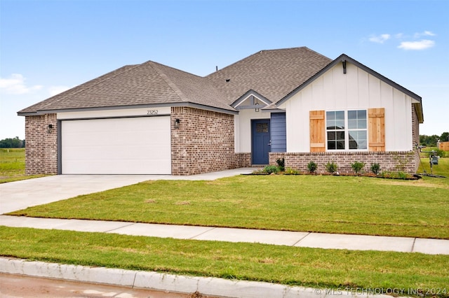 view of front of home with a front yard and a garage