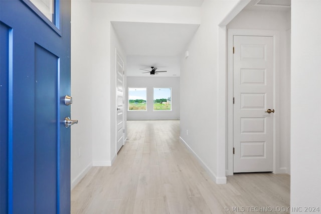 hallway with light hardwood / wood-style floors