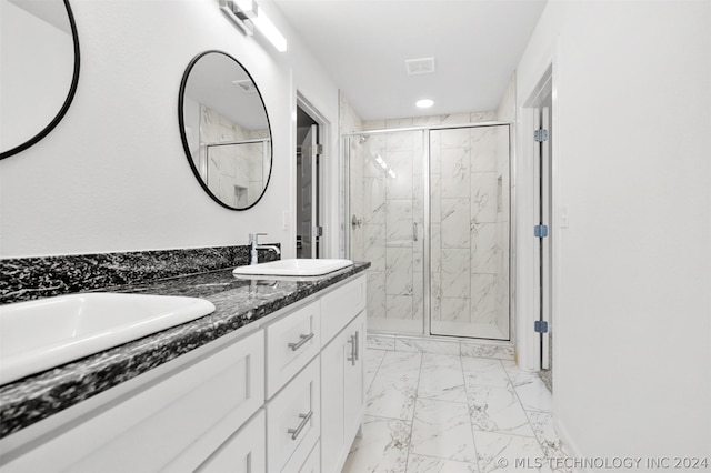 bathroom with vanity and a shower with door