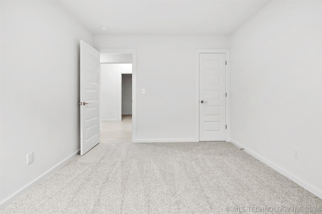 unfurnished room with light colored carpet