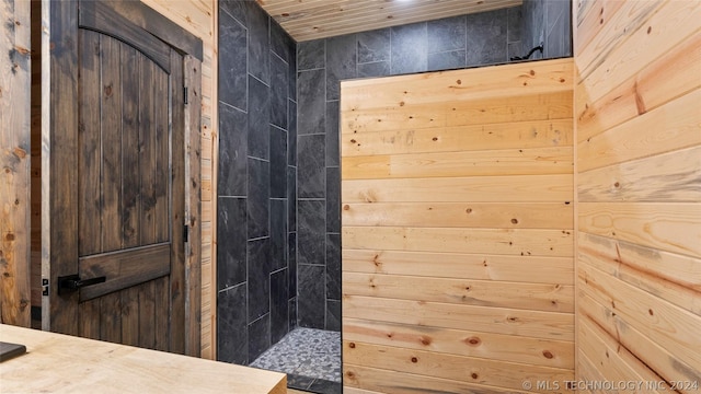 bathroom featuring wooden walls