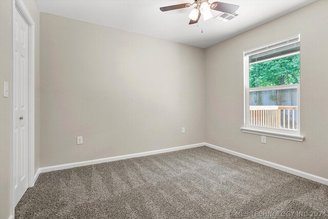 spare room with carpet flooring and ceiling fan