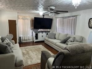 living room with ceiling fan and hardwood / wood-style floors