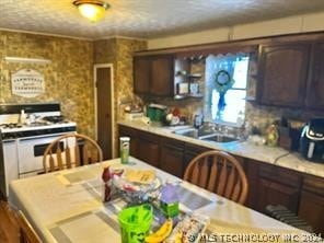 kitchen with dark brown cabinetry and gas range gas stove