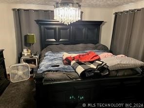 bedroom with a notable chandelier