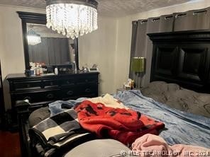 bedroom featuring an inviting chandelier