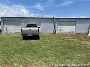 garage featuring a yard