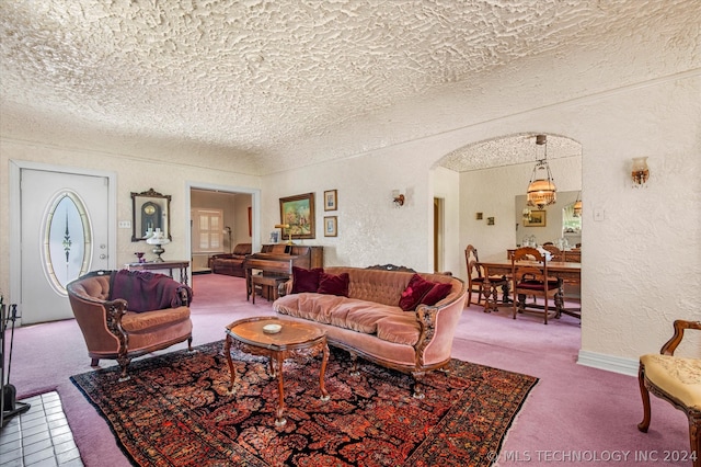 carpeted living room featuring a textured ceiling