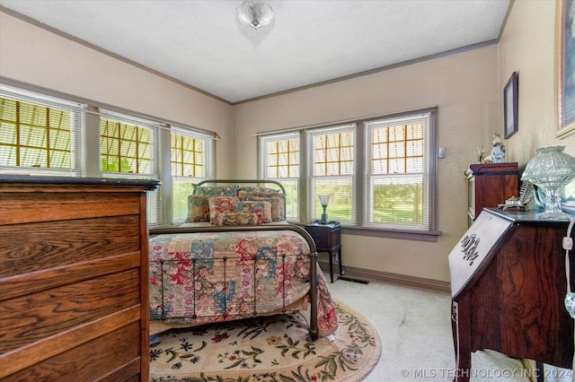 carpeted bedroom with crown molding and multiple windows