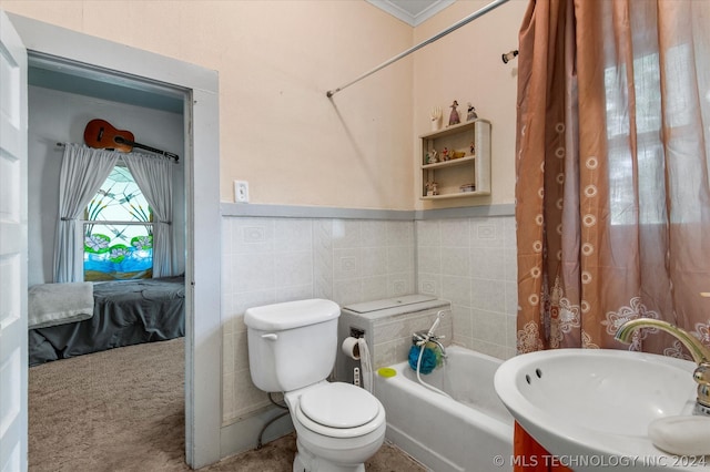 full bathroom featuring sink, tile walls, toilet, and shower / bath combo