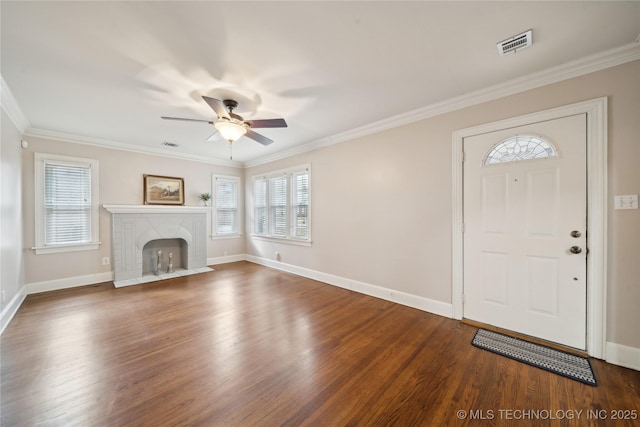 foyer entrance with hardwood / wood-style floors, ceiling fan, and crown molding