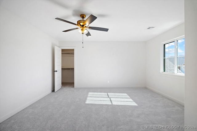 unfurnished room featuring light carpet and ceiling fan