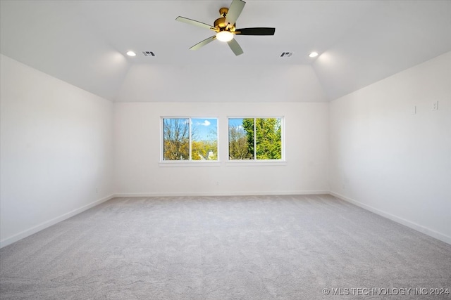 spare room with ceiling fan, carpet floors, and vaulted ceiling