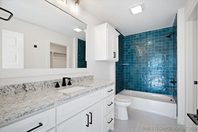 full bathroom with toilet, vanity, tile patterned floors, and tiled shower / bath