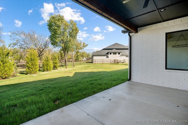 view of yard featuring ceiling fan and a patio area