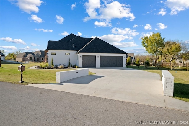 view of front of house with a garage and a front lawn