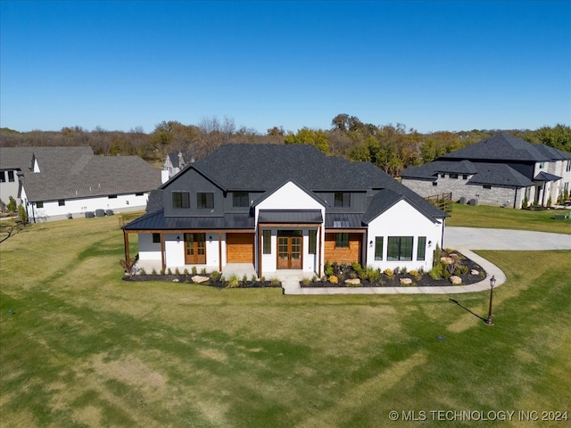 modern farmhouse style home featuring a front lawn